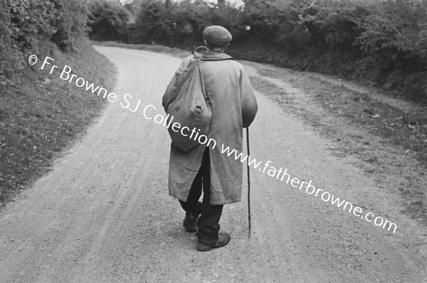 TRAMP WALKING ALONG ROAD